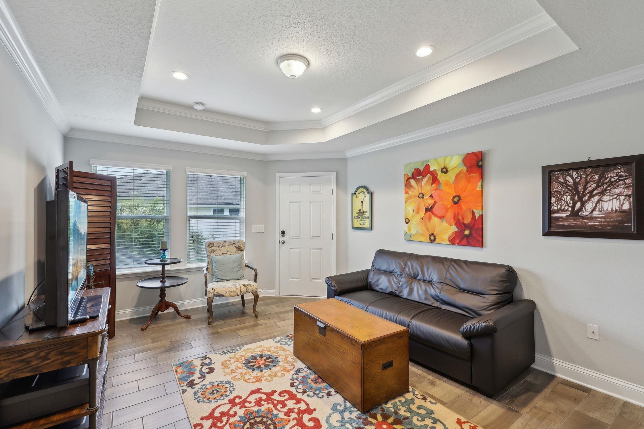 443 Sweet Mango Trail St. Augustine, FL 32086 - Photo 22 of 54 a living room with furniture flat screen tv and a fireplace
