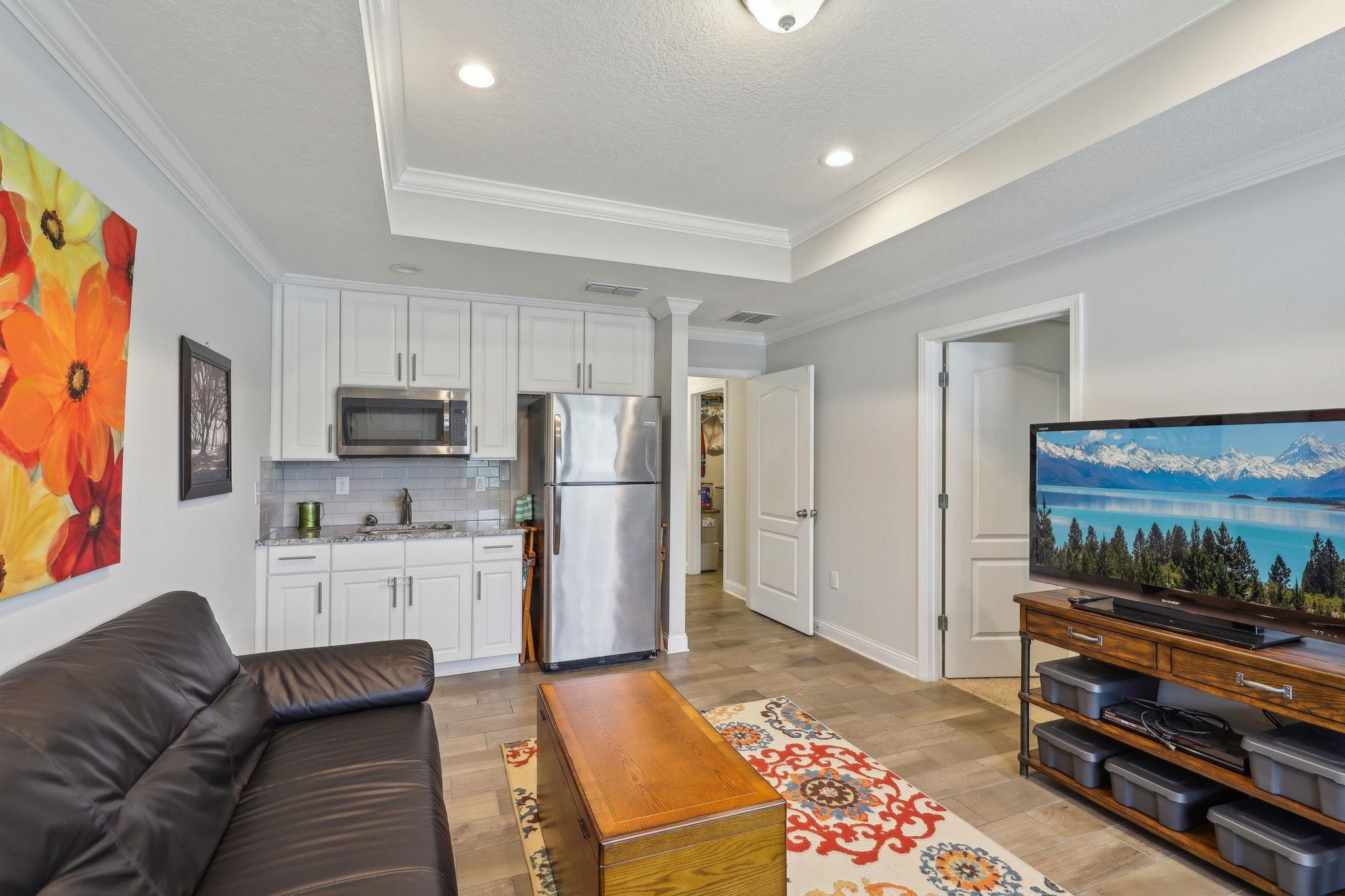 443 Sweet Mango Trail St. Augustine, FL 32086 - Photo 24 of 54 a living room with furniture and a flat screen tv