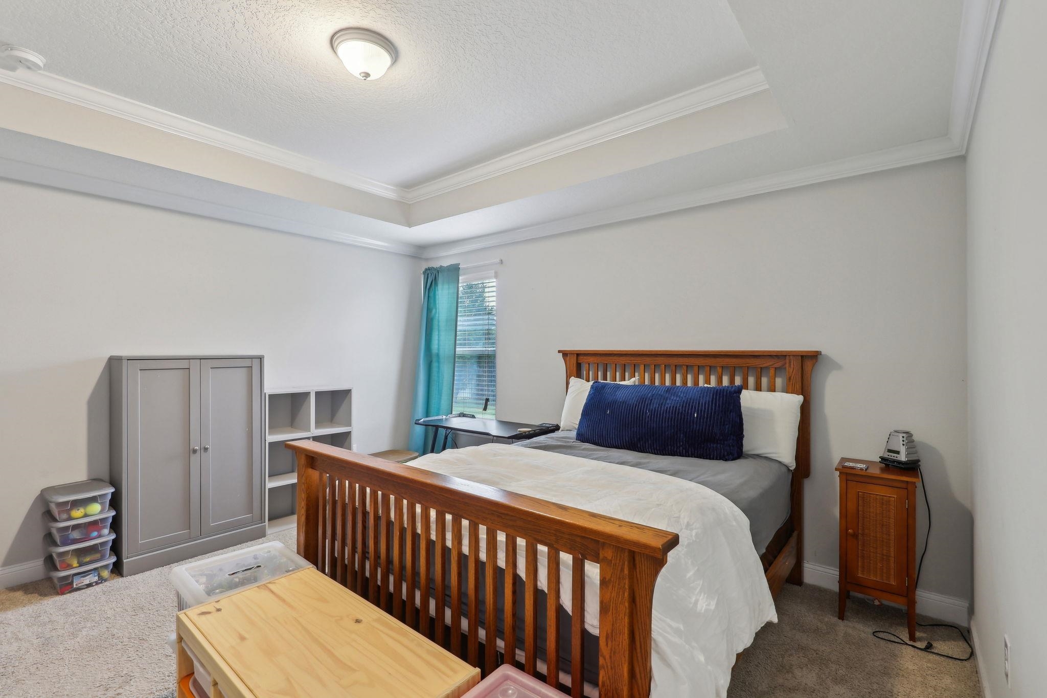 443 Sweet Mango Trail St. Augustine, FL 32086 - Photo 32 of 54 a bedroom with a bed and a window