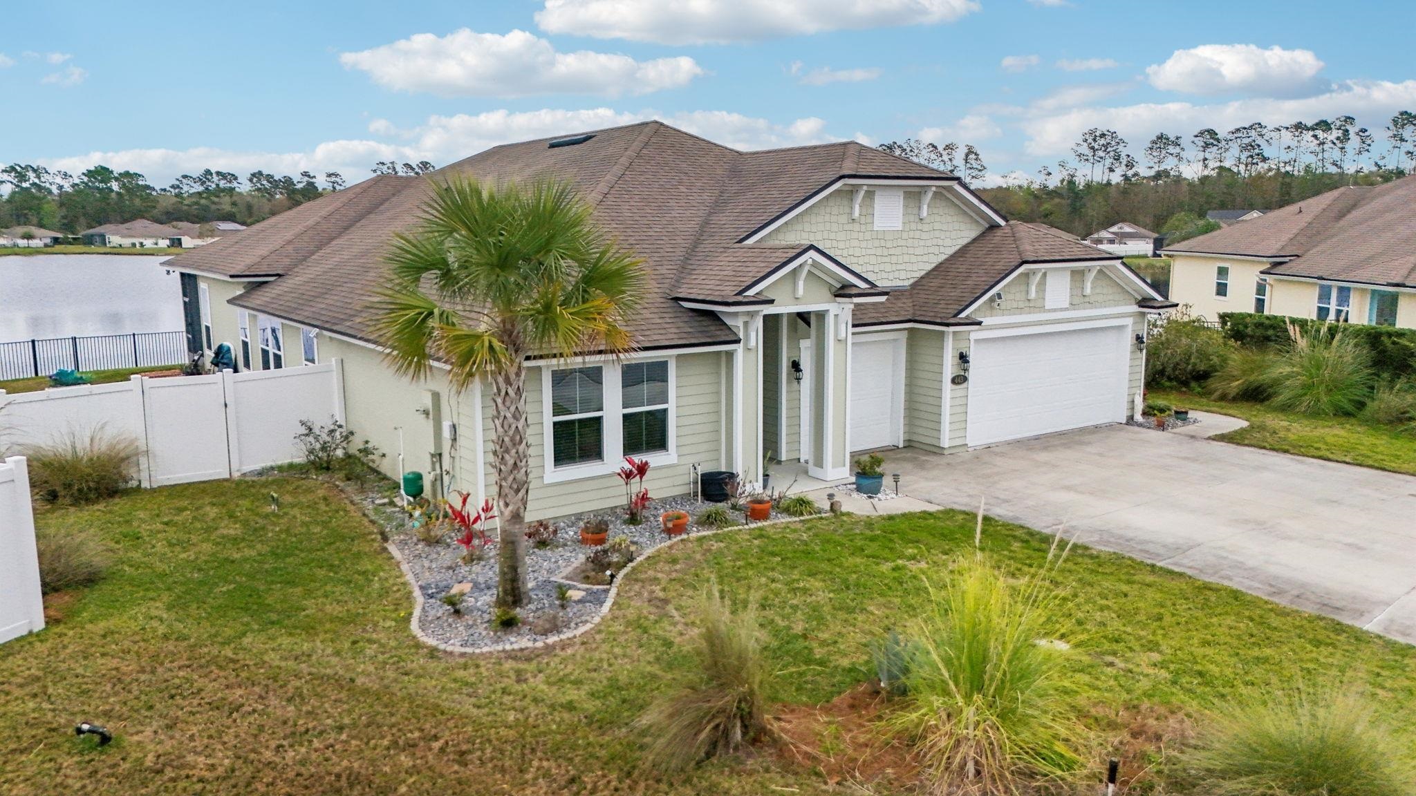 443 Sweet Mango Trail St. Augustine, FL 32086 - Photo 44 of 54 a front view of a house with garden
