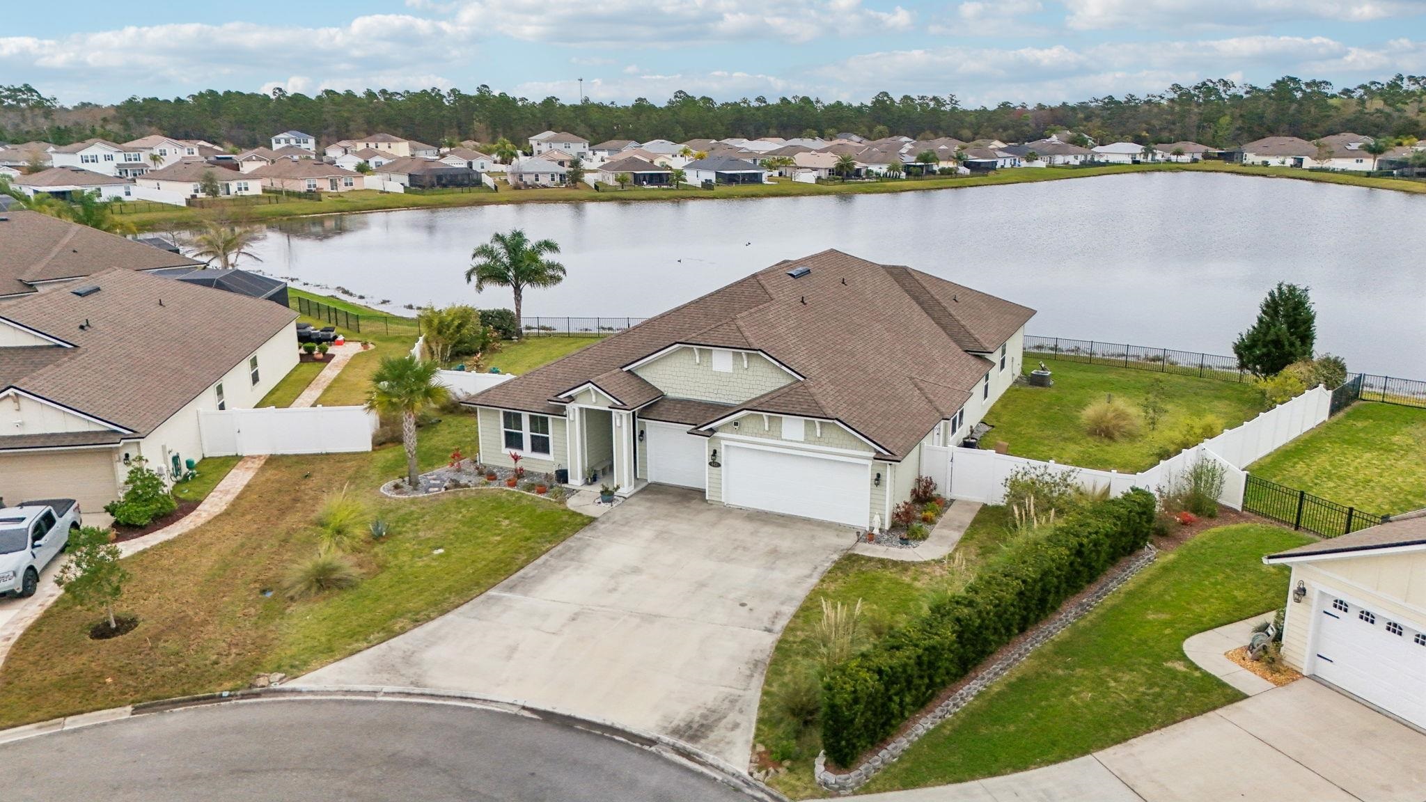 443 Sweet Mango Trail St. Augustine, FL 32086 - Photo 46 of 54 an aerial view of a house with outdoor space and lake view in back