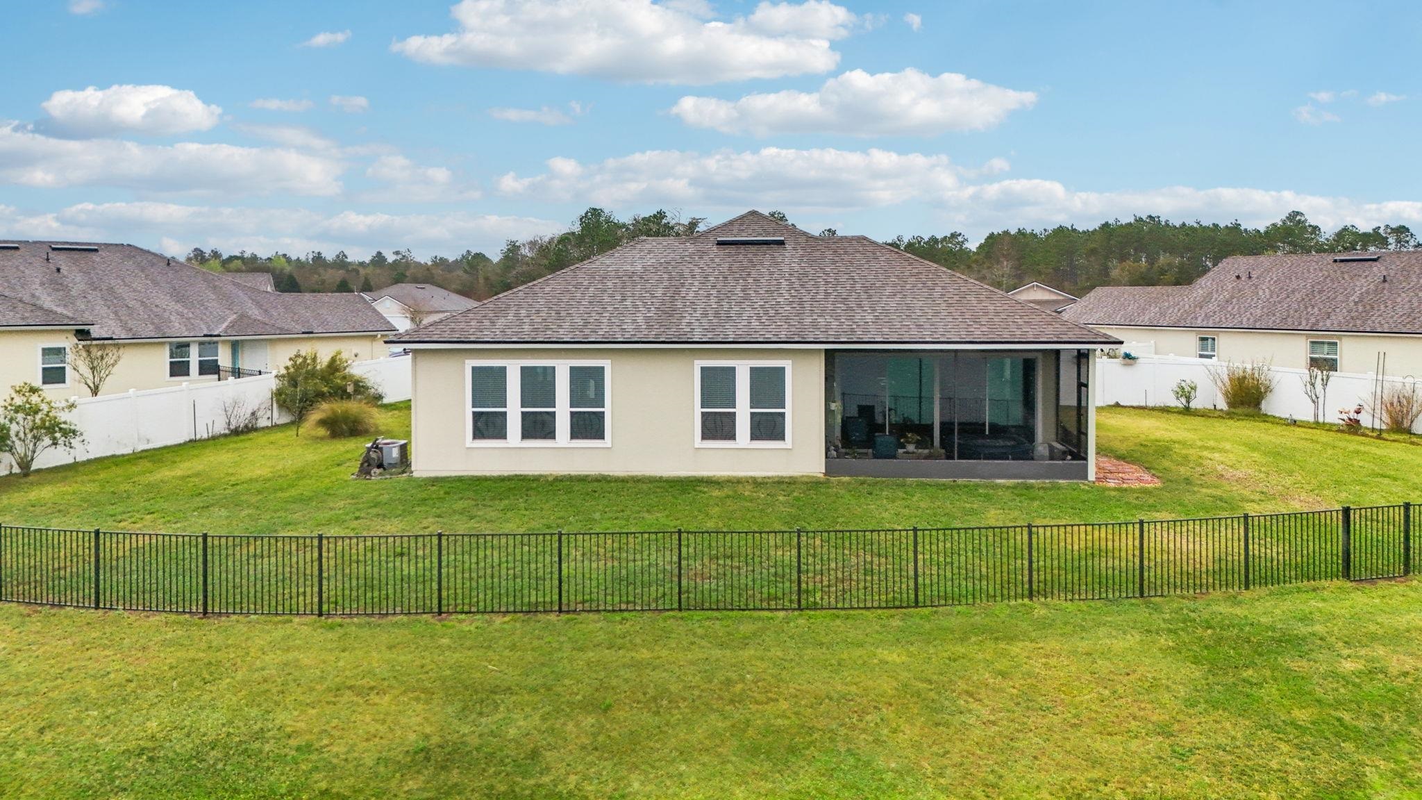 443 Sweet Mango Trail St. Augustine, FL 32086 - Photo 49 of 54 a view of a house next to a big yard