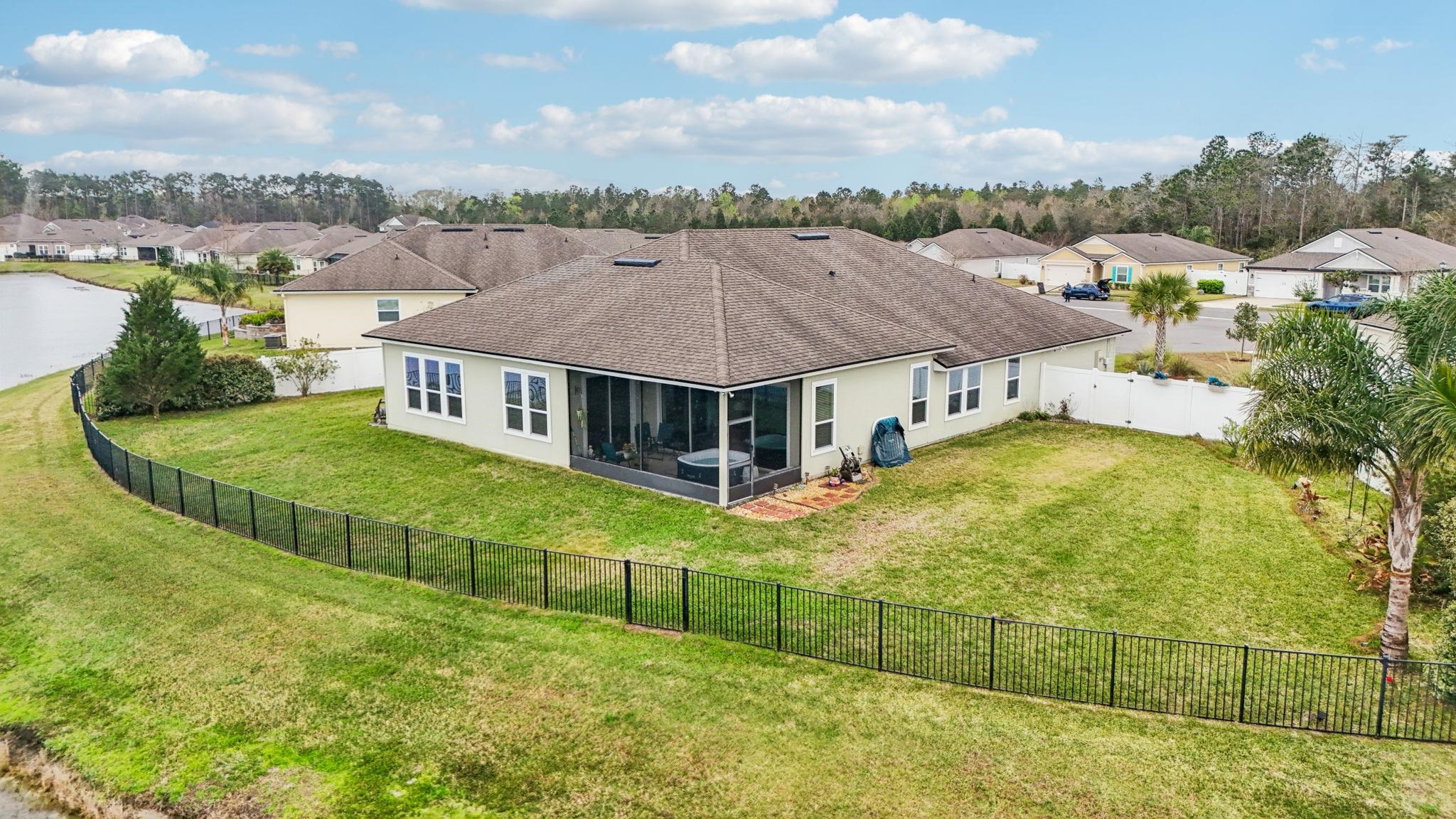 443 Sweet Mango Trail St. Augustine, FL 32086 - Photo 50 of 54 an aerial view of residential houses with outdoor space and swimming pool