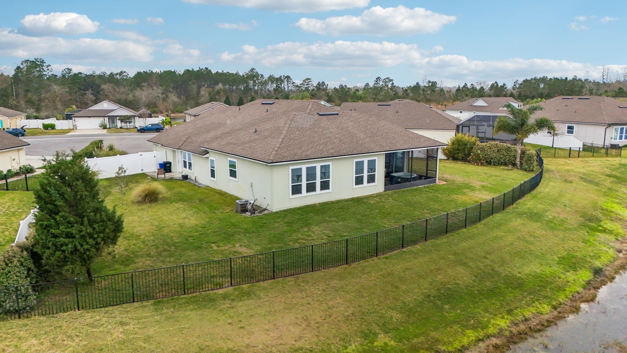 443 Sweet Mango Trail St. Augustine, FL 32086 - Photo 51 of 54 a aerial view of a house with pool lake view and mountain view