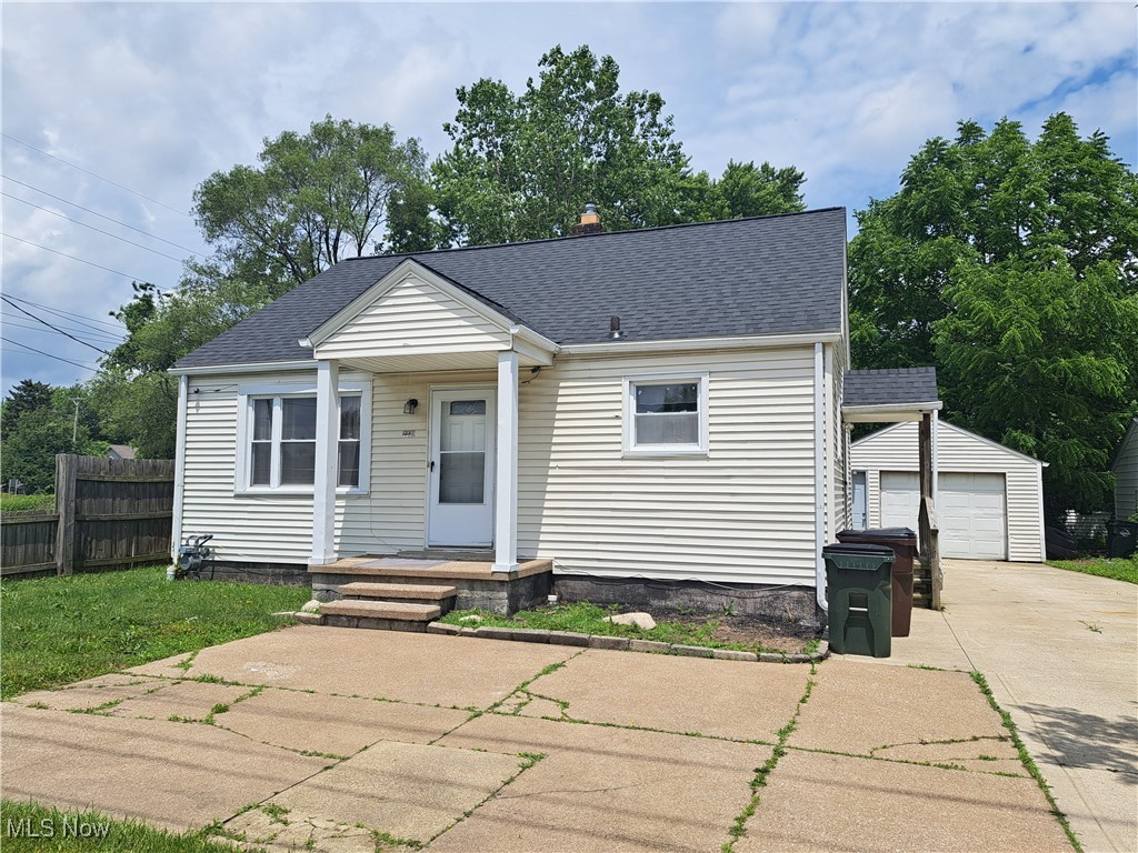 2239 North Ridge Road Lorain, OH 44055 - Photo 1 of 28 Bungalow-style house with driveway, an outbuilding, roof with shingles, and a detached garage