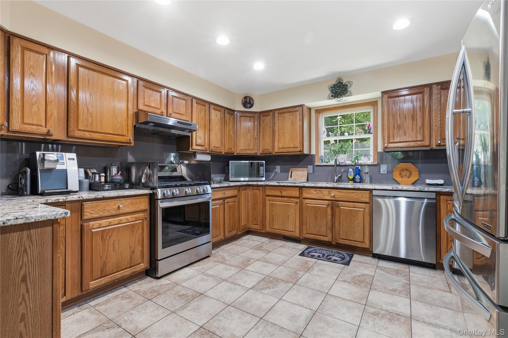 239-241 Fosler Road Highland, NY 12528 - Photo 10 of 42 Kitchen featuring wood cabinetry, stainless steel appliances, granite-style countertops, and a tile floor