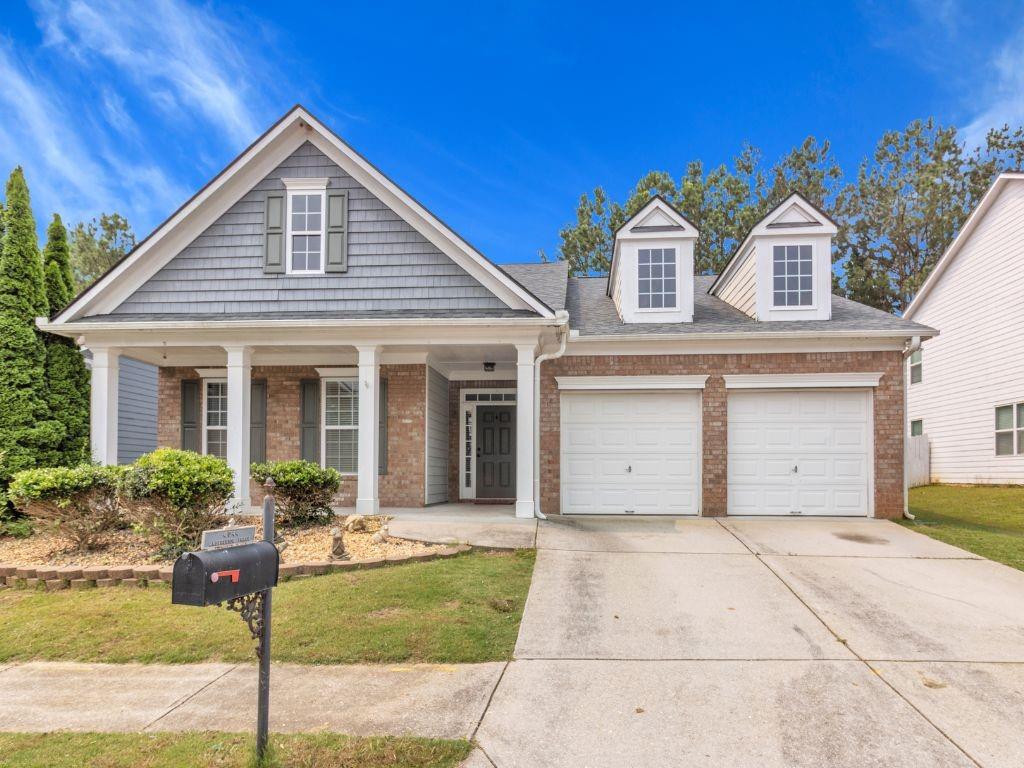 4044 Amberleigh Trace Gainesville, GA 30507 - Photo 1 of 22 a front view of a house with garden