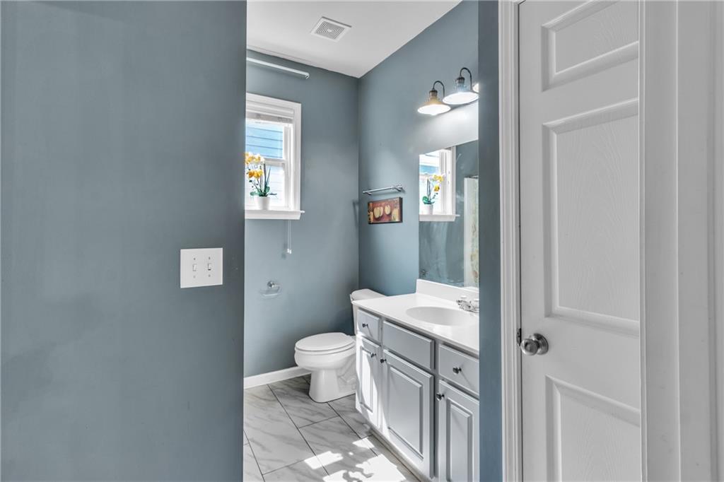 4044 Amberleigh Trace Gainesville, GA 30507 - Photo 11 of 22 a bathroom with a toilet sink and mirror