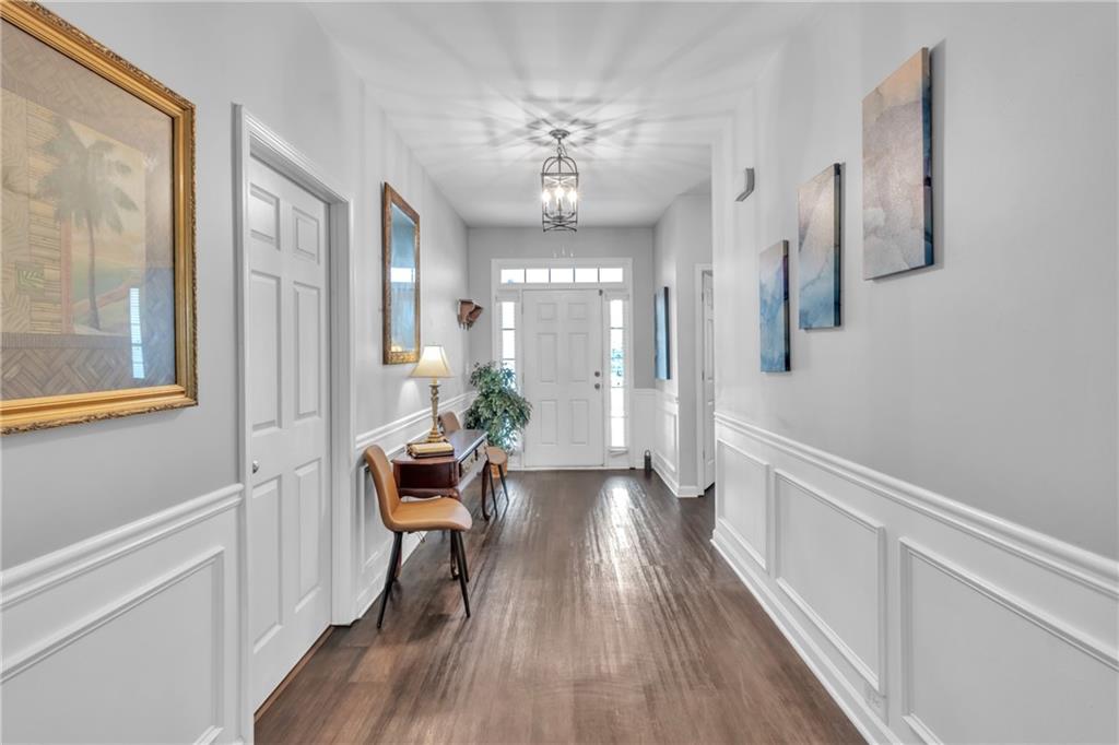 4044 Amberleigh Trace Gainesville, GA 30507 - Photo 14 of 22 a view of a hallway with wooden floor and a chandelier