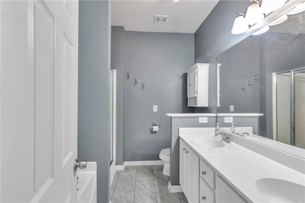 4044 Amberleigh Trace Gainesville, GA 30507 - Photo 21 of 22 a bathroom with a sink a toilet and shower