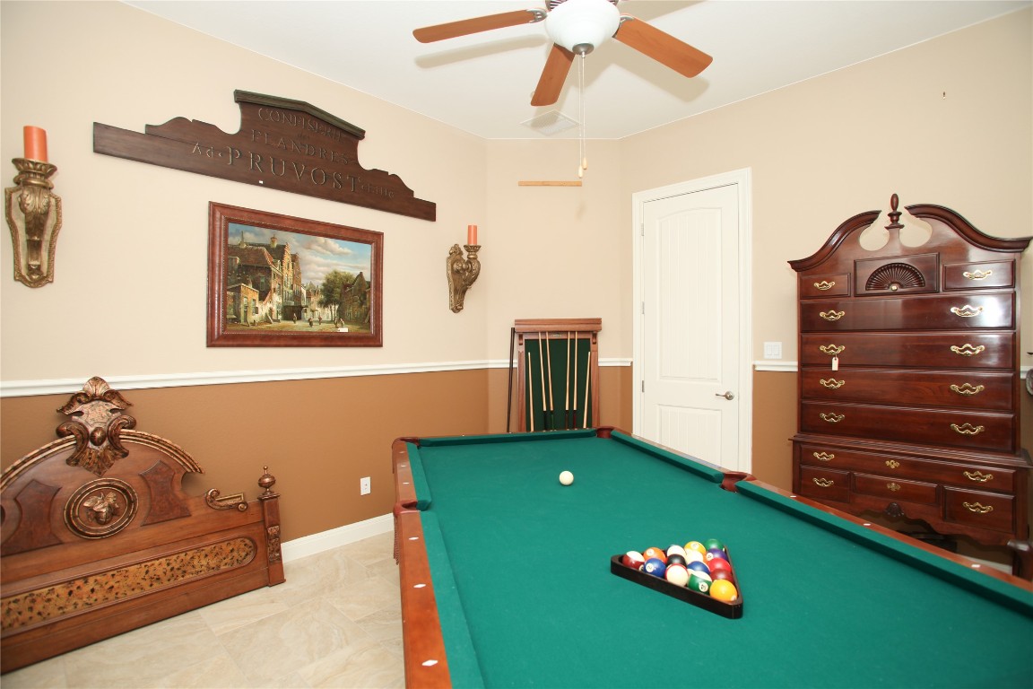 1589 Cool Spring Way Austin, TX 78737 - Photo 17 of 35 a bedroom with a bed and a chandelier