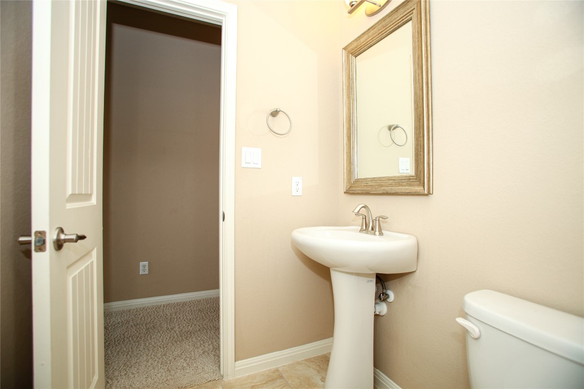 1589 Cool Spring Way Austin, TX 78737 - Photo 24 of 35 a bathroom with a sink toilet and a mirror