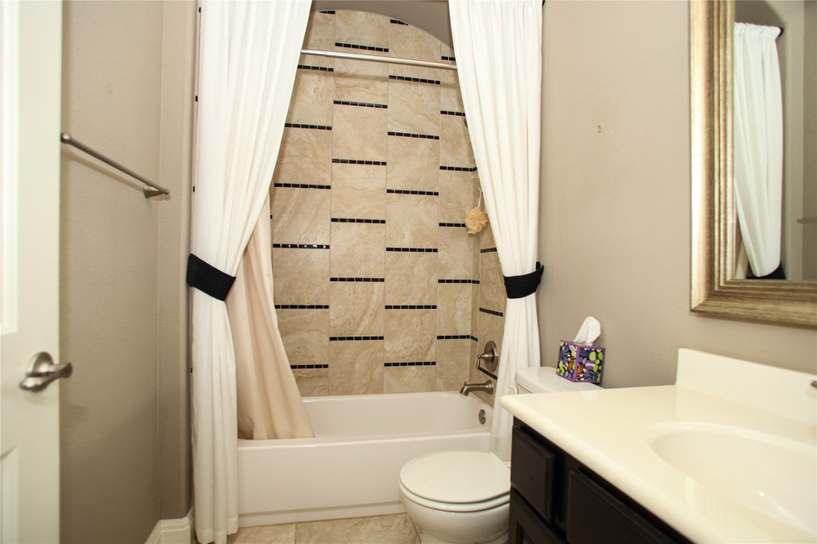 1589 Cool Spring Way Austin, TX 78737 - Photo 26 of 35 a bathroom with a sink toilet and shower