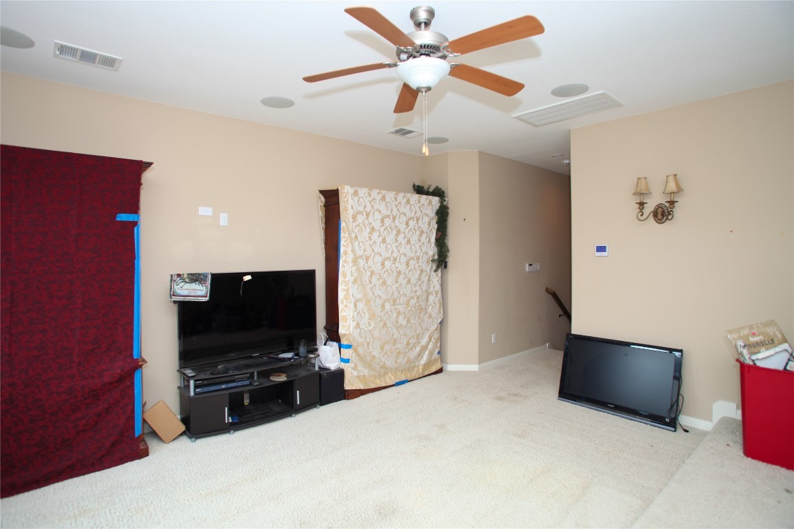 1589 Cool Spring Way Austin, TX 78737 - Photo 29 of 35 a living room with furniture and a flat screen tv