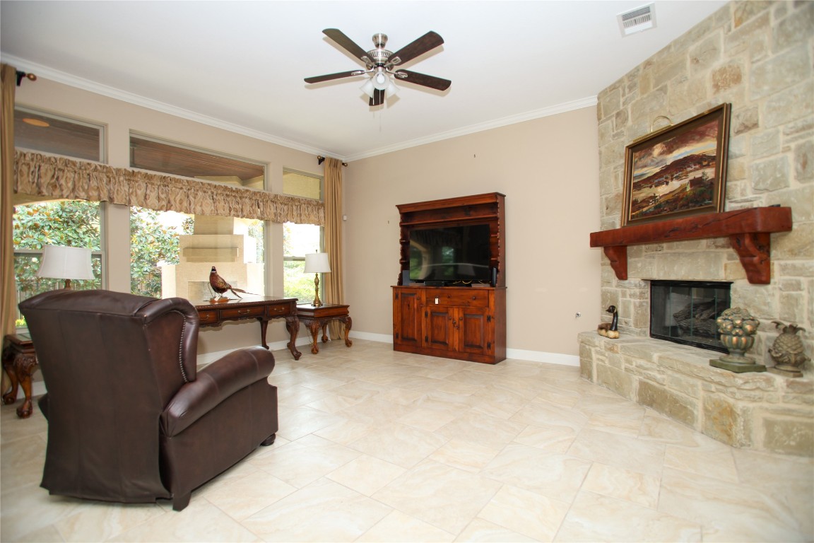 1589 Cool Spring Way Austin, TX 78737 - Photo 4 of 35 a living room with furniture and a fireplace