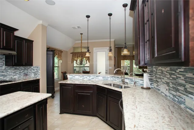 a kitchen with a sink stove and refrigerator
