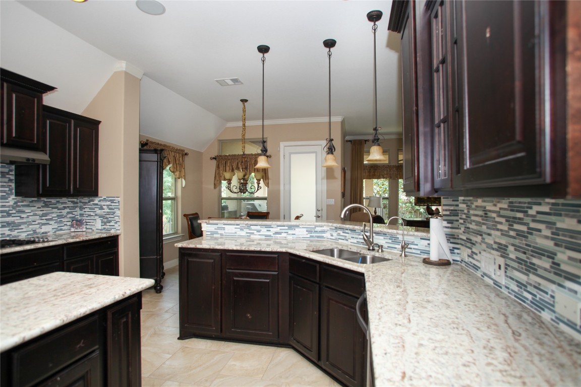 1589 Cool Spring Way Austin, TX 78737 - Photo 8 of 35 a kitchen with a sink stove and refrigerator
