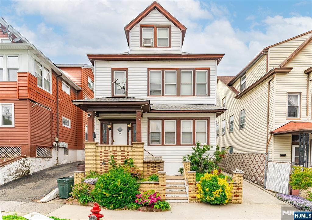 73-75 Knickerbocker Avenue Paterson, NJ 07503 - Photo 1 of 27 a front view of a residential houses with yard