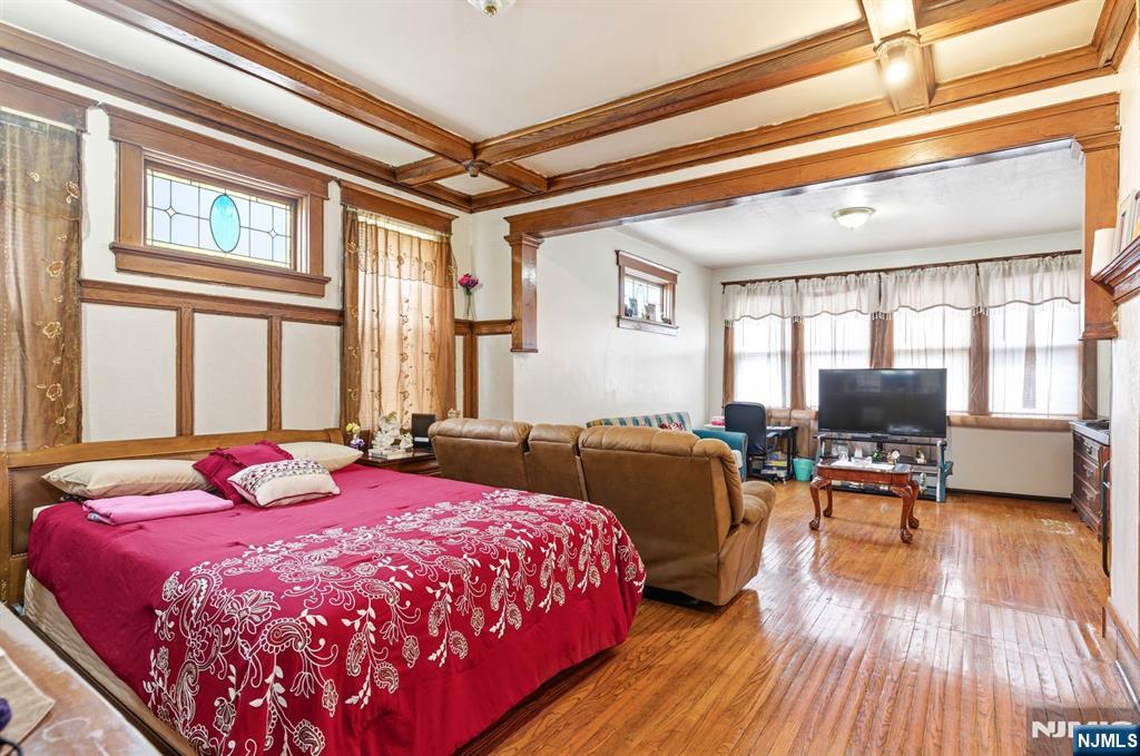 73-75 Knickerbocker Avenue Paterson, NJ 07503 - Photo 14 of 27 a bedroom with a bed and wooden floor