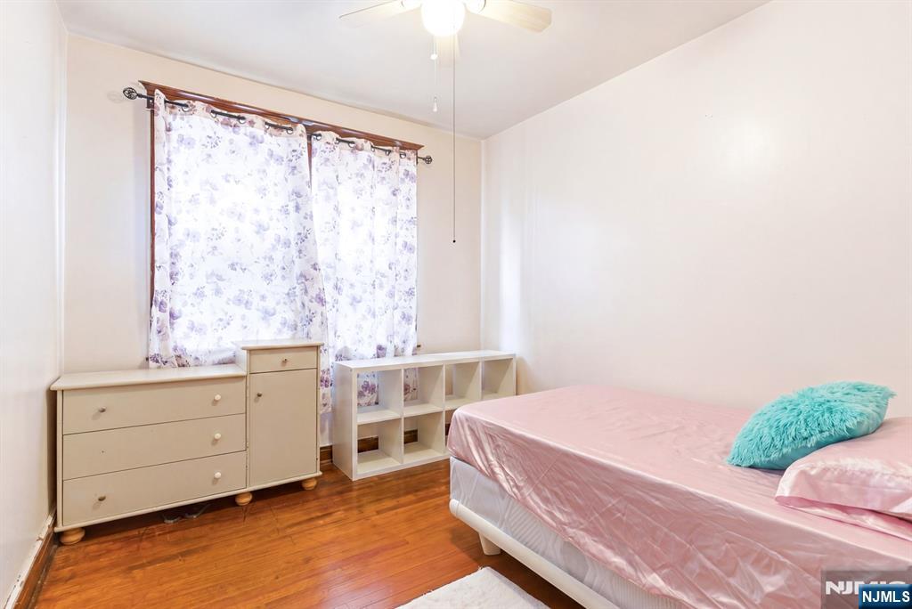 73-75 Knickerbocker Avenue Paterson, NJ 07503 - Photo 17 of 27 a bedroom with a bed and a dresser