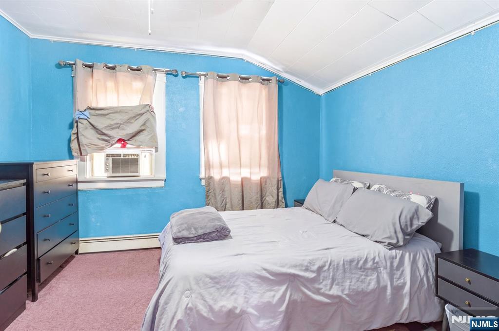 73-75 Knickerbocker Avenue Paterson, NJ 07503 - Photo 20 of 27 a bedroom with a bed and a window
