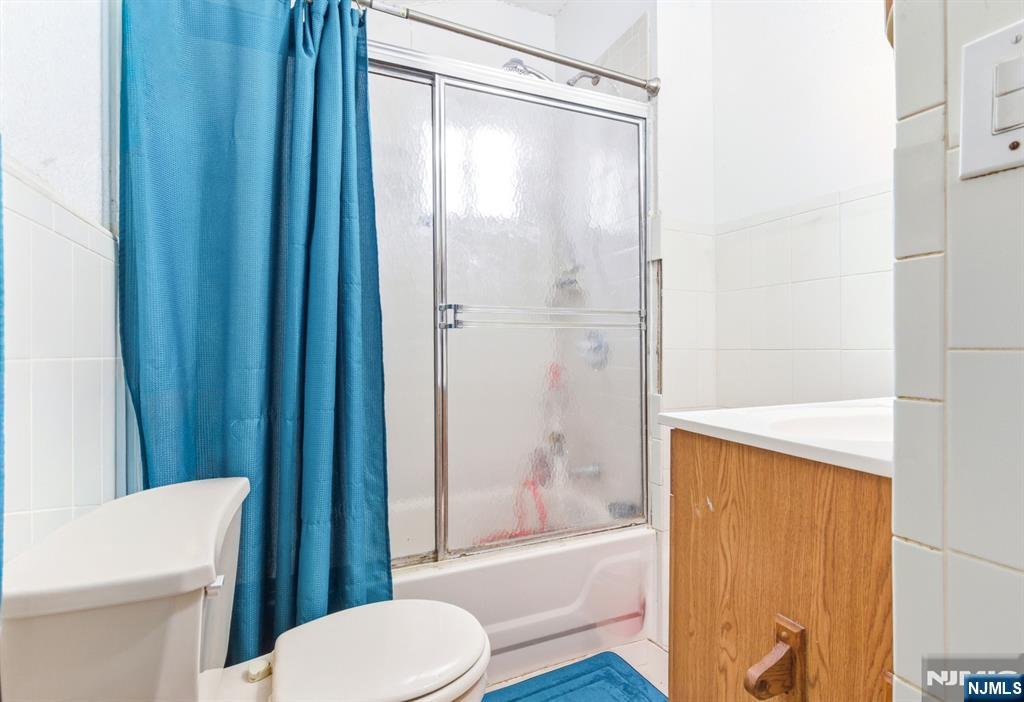 73-75 Knickerbocker Avenue Paterson, NJ 07503 - Photo 23 of 27 a bathroom with a shower and a toilet