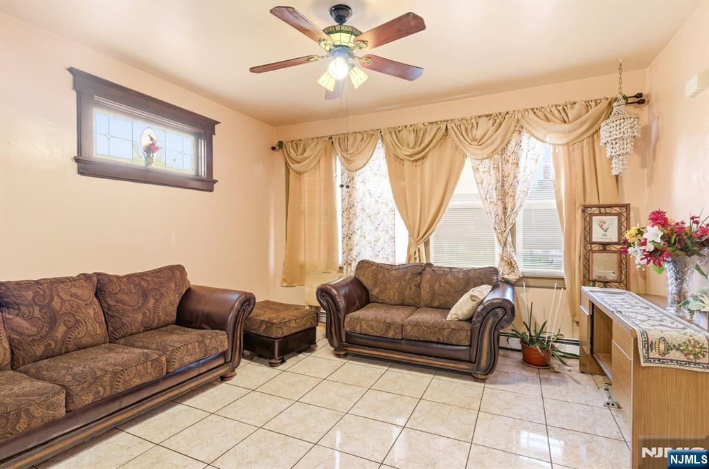 73-75 Knickerbocker Avenue Paterson, NJ 07503 - Photo 3 of 27 a living room with furniture and a large window