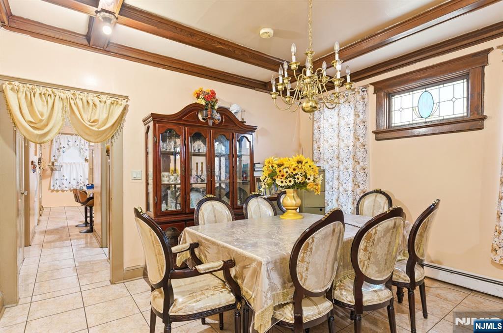 73-75 Knickerbocker Avenue Paterson, NJ 07503 - Photo 4 of 27 a view of a dining room with furniture and chandelier