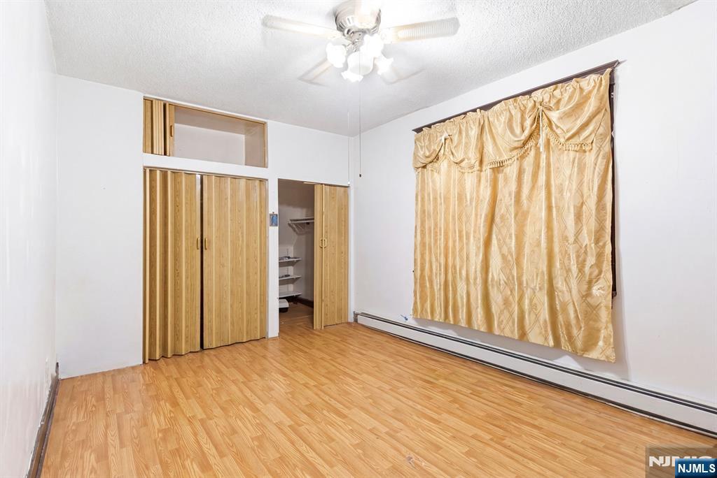 73-75 Knickerbocker Avenue Paterson, NJ 07503 - Photo 7 of 27 wooden floor in an empty room with a window