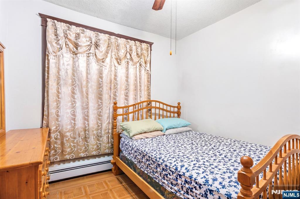 73-75 Knickerbocker Avenue Paterson, NJ 07503 - Photo 9 of 27 a bedroom with a bed and a window