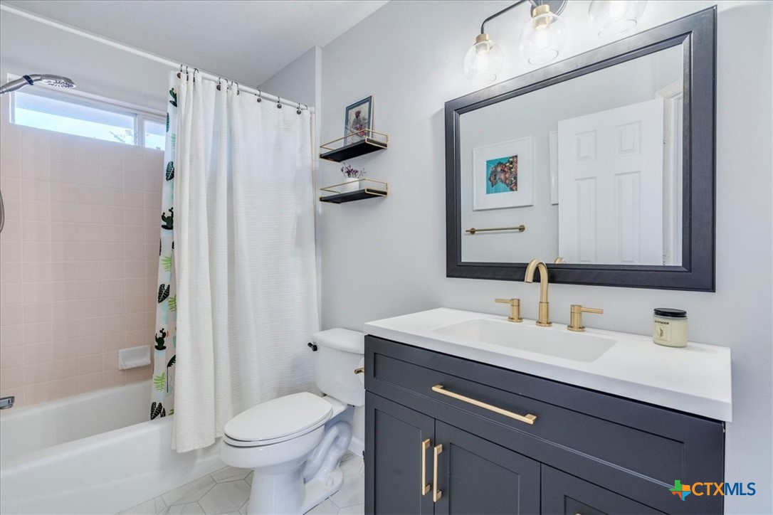 171 Pin Oak Crossing Elgin, TX 78621 - Photo 26 of 38 a bathroom with a sink toilet and shower