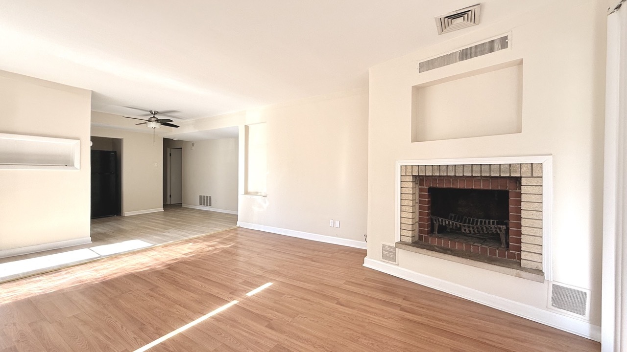1828 183rd Street Homewood, IL 60430 - Photo 5 of 21 a view of an empty room with wooden floor and a fireplace