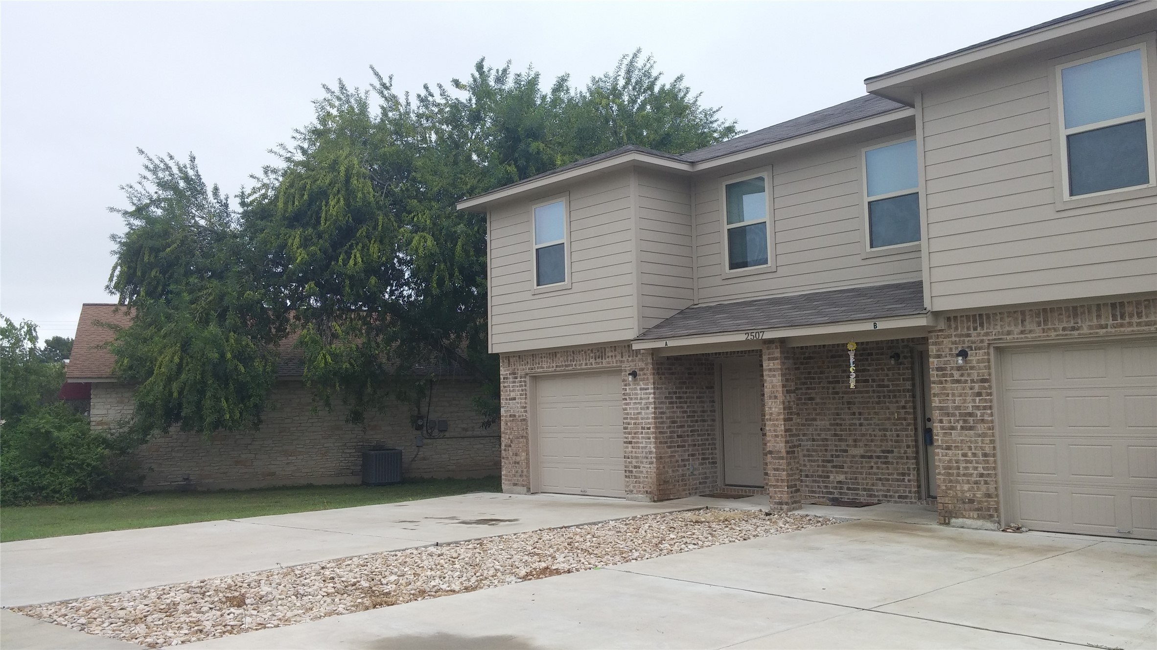 2507 Oak Lane, Unit A Georgetown, TX 78628 - Photo 2 of 11 A classic brick and siding duplex awaits new residents.
