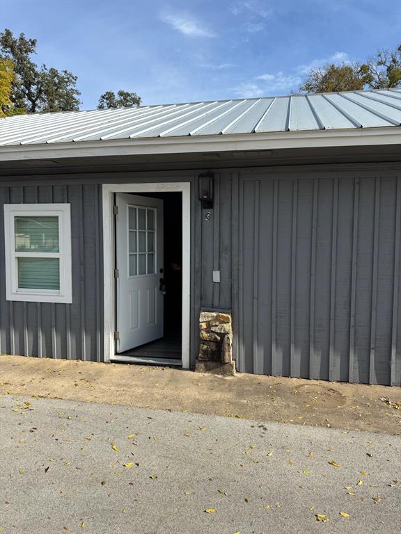 9551 Lechner Road, Unit G Fort Worth, TX 76179 - Photo 9 of 15 Gray vertical siding exterior with a white door featuring divided lites