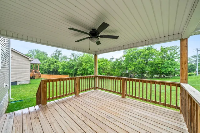 a view of backyard with a deck and wooden floor