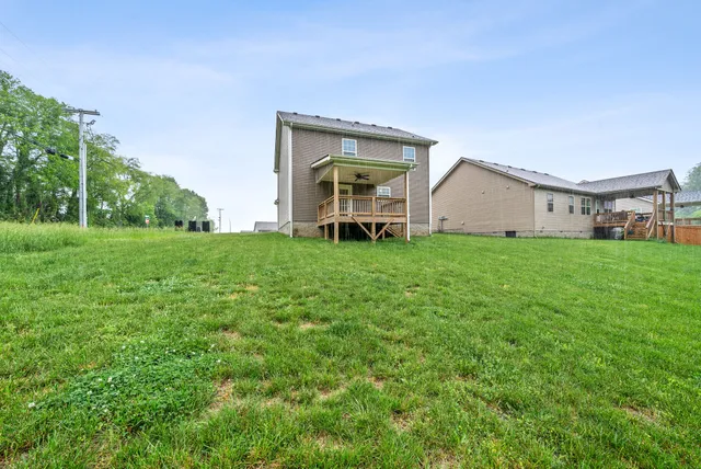a view of a house with a yard and sitting area
