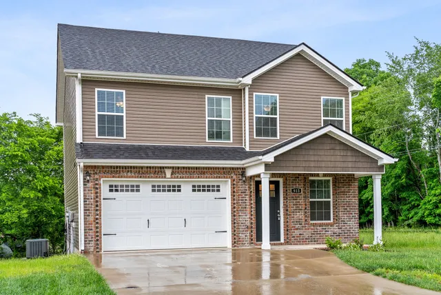 front view of a house with a yard