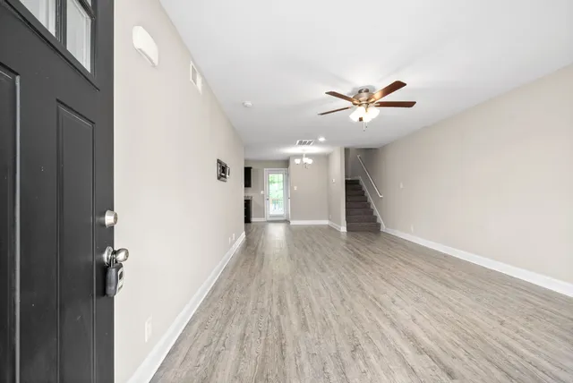 a view of empty room with wooden floor