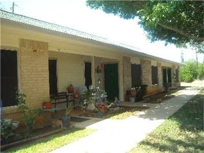 a front view of a house with lots of potted plants