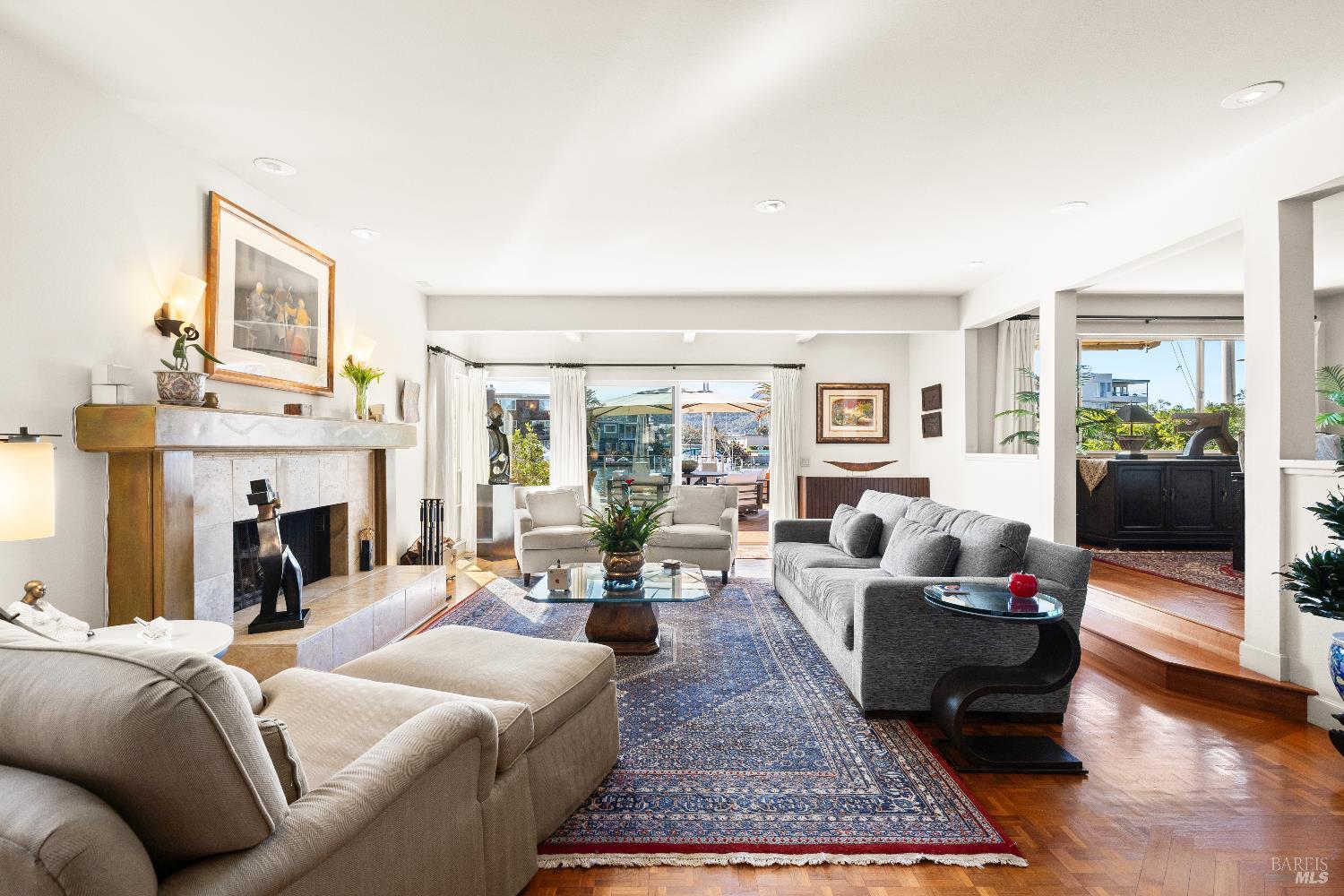 26 Mooring Road San Rafael, CA 94901 - Photo 12 of 60 The inviting living room flows directly out to the entertaining deck and boat dock and features teak parquet floors and a wood burning fireplace with gas starter.