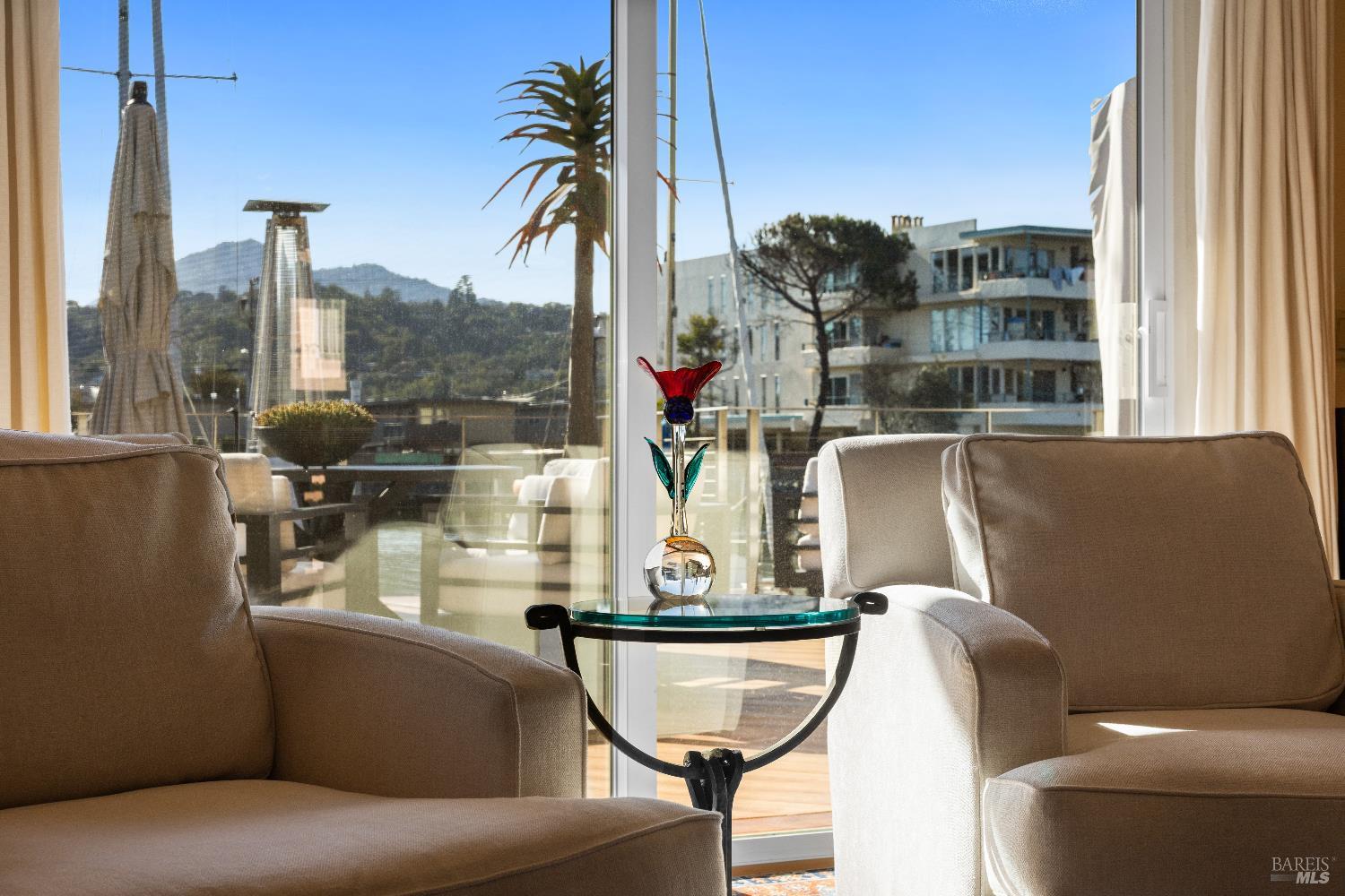 26 Mooring Road San Rafael, CA 94901 - Photo 13 of 60 The inviting living room flows directly out to the entertaining deck and boat dock and features teak parquet floors and a wood burning fireplace with gas starter.