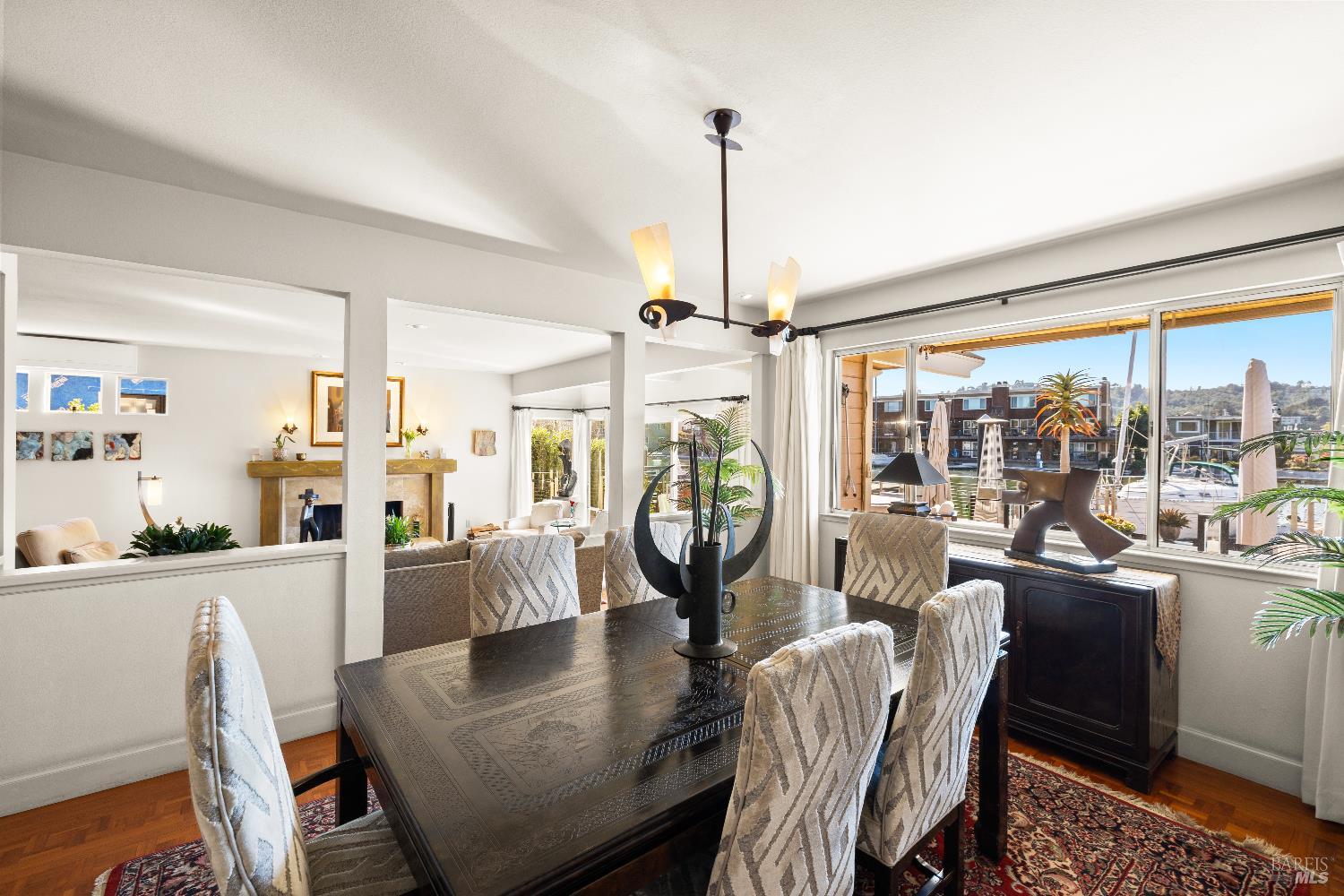 26 Mooring Road San Rafael, CA 94901 - Photo 16 of 60 The dining area is open to the living room and kitchen and features teak parquet floors and views out to the deck, water and Mt. Tam.