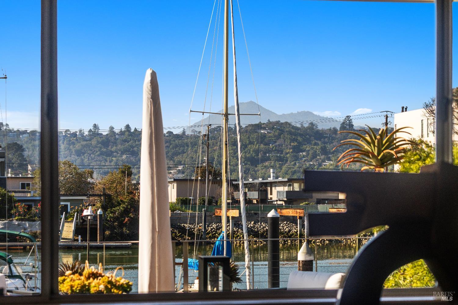 26 Mooring Road San Rafael, CA 94901 - Photo 17 of 60 The dining area is open to the living room and kitchen and features teak parquet floors and views out to the deck, water and Mt. Tam.