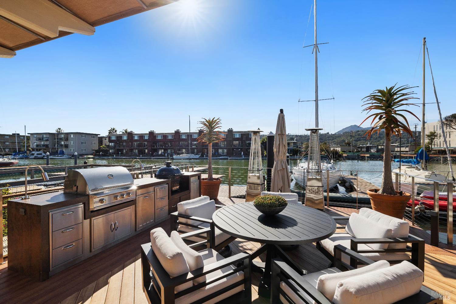 26 Mooring Road San Rafael, CA 94901 - Photo 22 of 60 The stunning entertaining deck is just off the living room and includes an outdoor kitchen and built in awnings and umbrellas. A ramp leads out to the 2-slip boat dock.