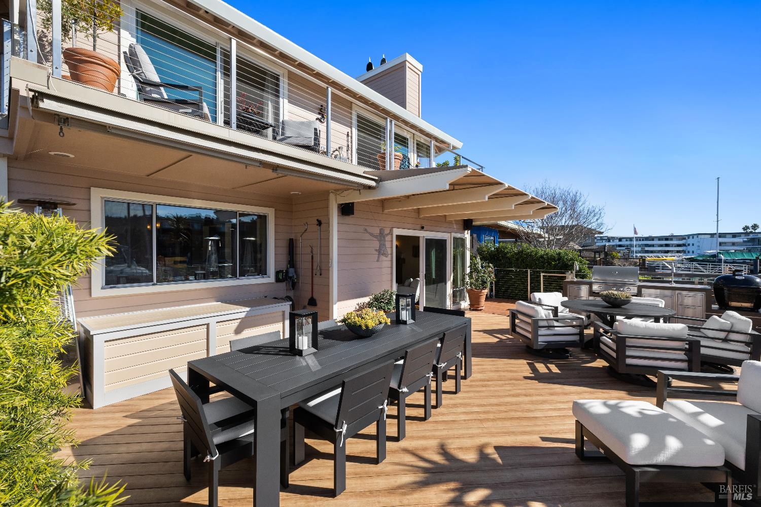 26 Mooring Road San Rafael, CA 94901 - Photo 25 of 60 The stunning entertaining deck is just off the living room and includes an outdoor kitchen and built in awnings and umbrellas. A ramp leads out to the 2-slip boat dock.