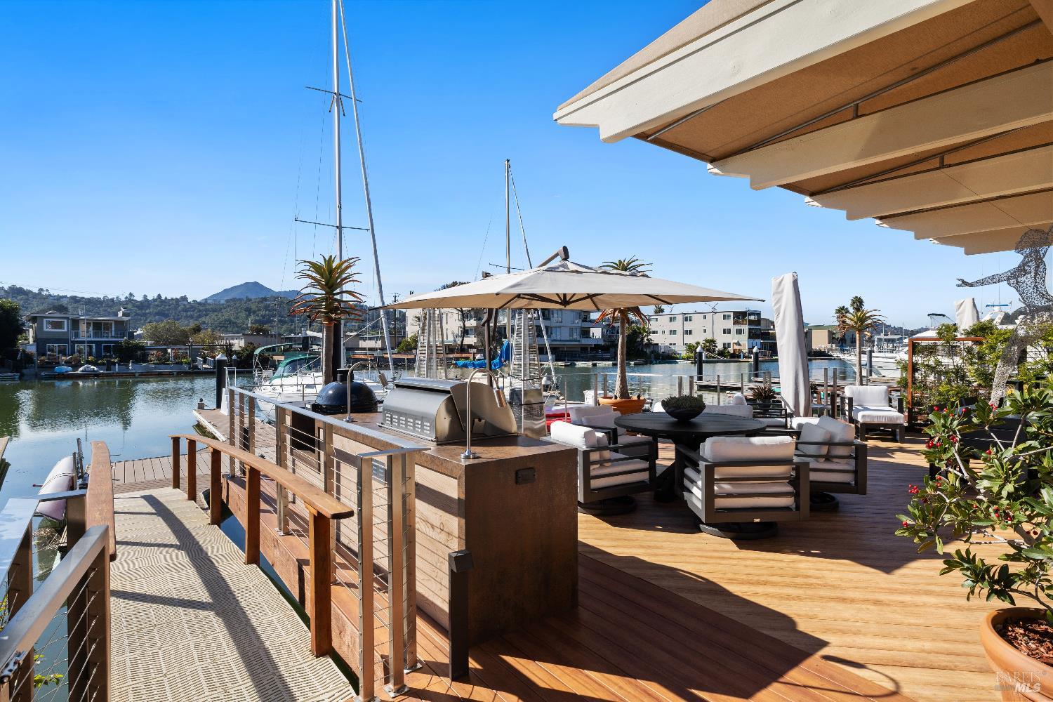 26 Mooring Road San Rafael, CA 94901 - Photo 27 of 60 The stunning entertaining deck is just off the living room and includes an outdoor kitchen and built in awnings and umbrellas. A ramp leads out to the 2-slip boat dock.