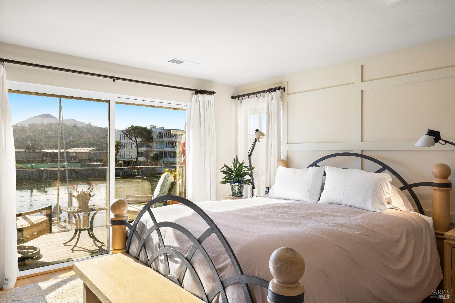 26 Mooring Road San Rafael, CA 94901 - Photo 35 of 60 The spacious primary bedroom looks out to the water and Mt. Tam and includes a lovely sitting area with a gas fireplace, built-in cabinetry, hardwood floors, a walk-in closet and ensuite bathroom. Sliding doors open out to a balcony perfect for enjoying the stunning views.