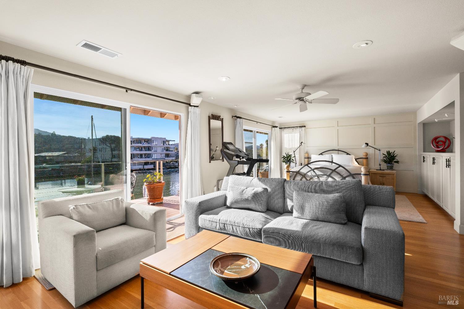 26 Mooring Road San Rafael, CA 94901 - Photo 39 of 60 The spacious primary bedroom looks out to the water and Mt. Tam and includes a lovely sitting area with a gas fireplace, built-in cabinetry, hardwood floors, a walk-in closet and ensuite bathroom. Sliding doors open out to a balcony perfect for enjoying the stunning views.