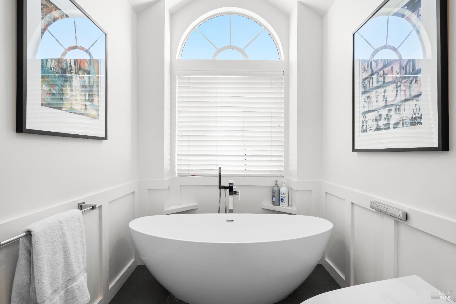 26 Mooring Road San Rafael, CA 94901 - Photo 47 of 60 The remodeled spa-like primary bath includes a custom vanity, custom tile walk-in shower with glass surround, bidet toilet and soaking tub.