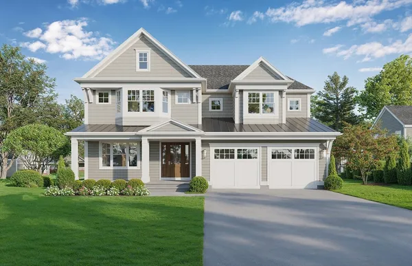 a front view of a house with a garden and yard